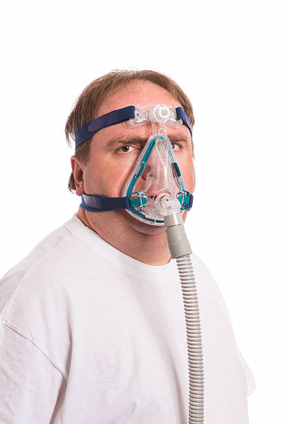 istock A man wearing a sleep apnea mask 180918145