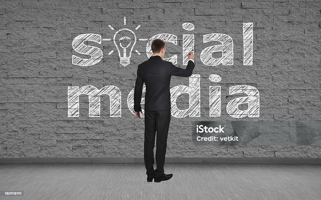 man drawing social media businessman drawing social media on brick wall Adult Stock Photo