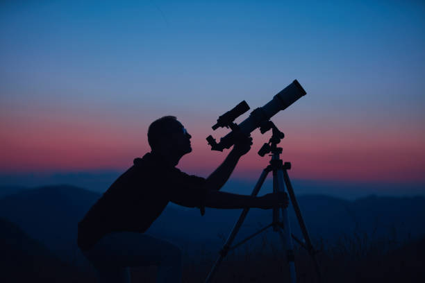 istock Astronomer looking at the night sky with a telescope. 1809188328