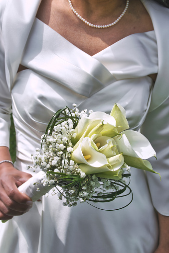 Bride holding her bouquet in her han