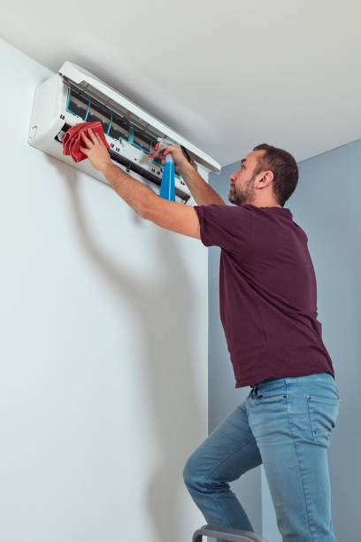 istock Man cleaning and maintaining air condition unit. 1809190950