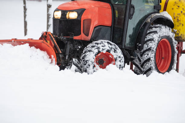 istock Tractor cleaning urban park paths on a cold snowy day. 1809195650
