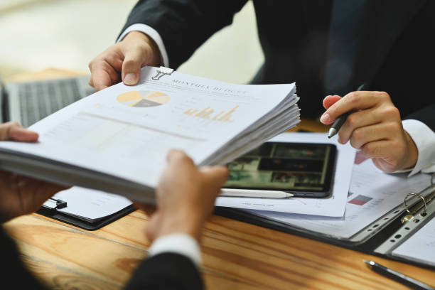 istock Financial inspector hands handing document over meeting table in office 1809196159