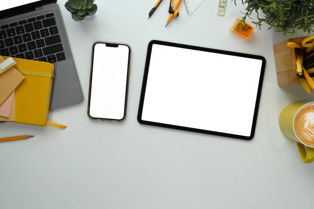 istock White office desk with digital tablet, laptop and supplies. Flat lay, top view with copy space 1809197295