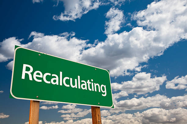 istock Recalculating Green Road Sign with Sky 180920715