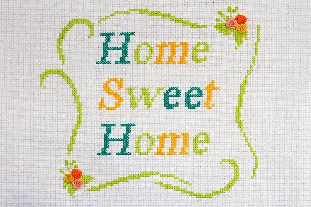 Colored thread on canvas embroidered with the phrase home sweet home