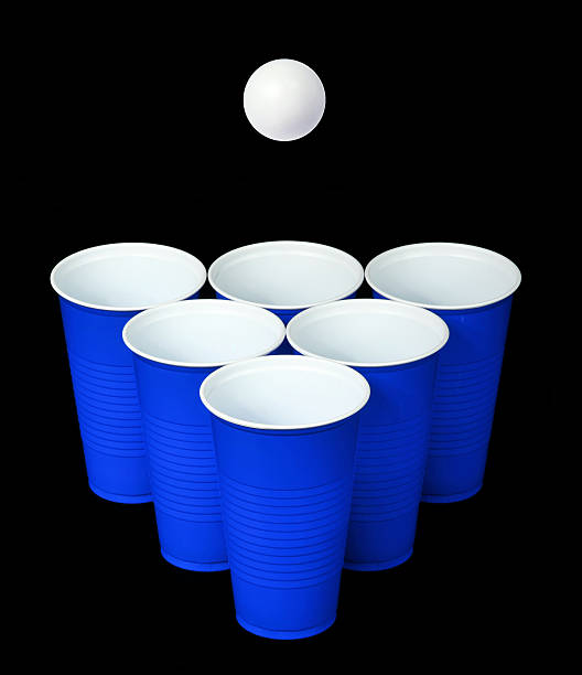 istock Beer pong. Blue plastic cups and ball over black 180921162