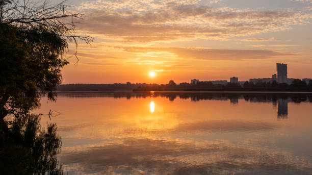 istock Sunrise sun shining on lake mirror water surface 1809215071