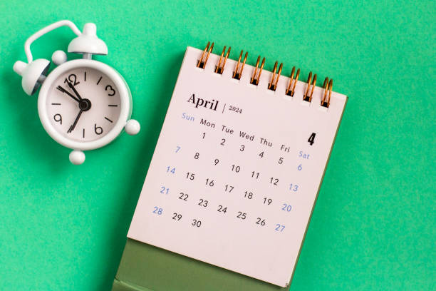 istock Desk calendar for April 2024 on a green background. 1809222663