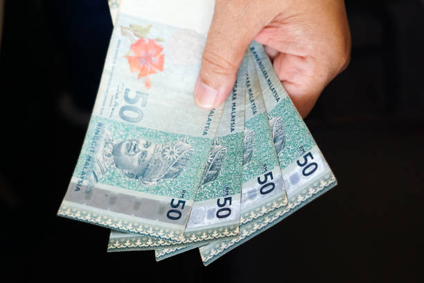 istock Hand holding cash, in selective focus 1809233990