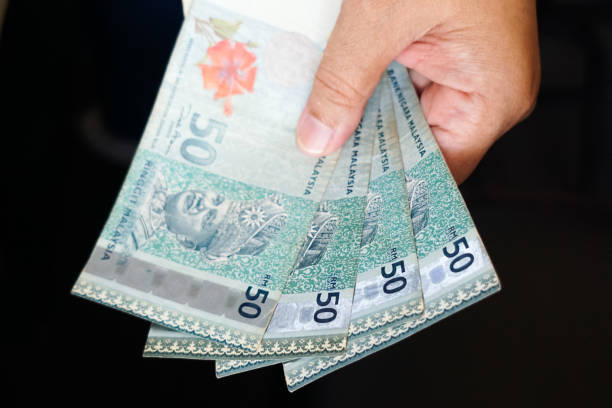 istock Hand holding cash, in selective focus 1809234495