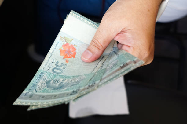 istock Hand holding cash, in selective focus 1809234499