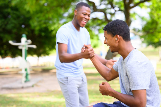 istock Friends shake hands exercising together in park 1809239803