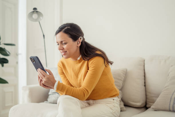 istock Hearing impaired woman using cellphone at home 1809240877