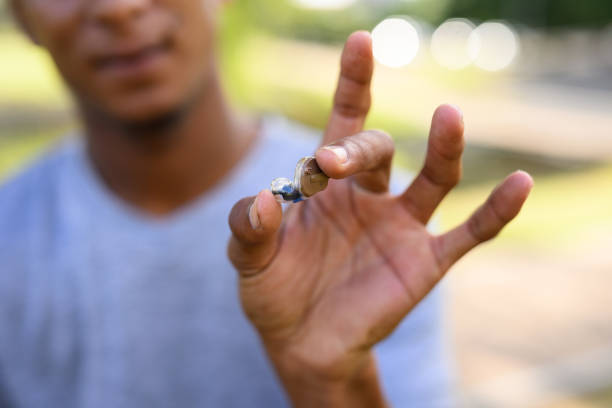 Young man wearing hearing aid exercising with friend in the park