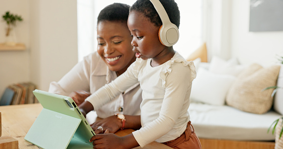 Tablet, black mother and girl on video call, being happy and wave with smile in living room at home. Mama, child and daughter with digital device for connect, smile and bonding to blow kiss in lounge