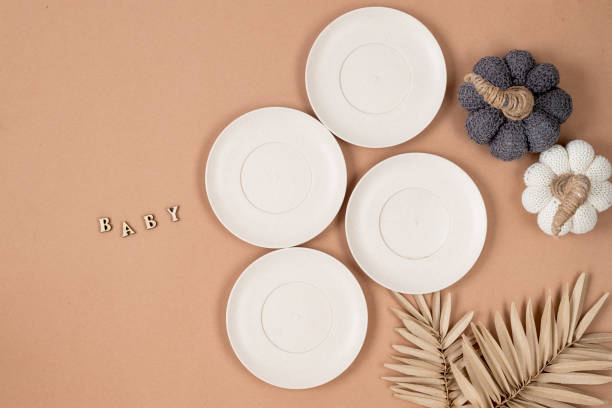 istock Flat lay composition with silicone baby beige dishware on pastel beige color background. Minimal concept. 1809266424