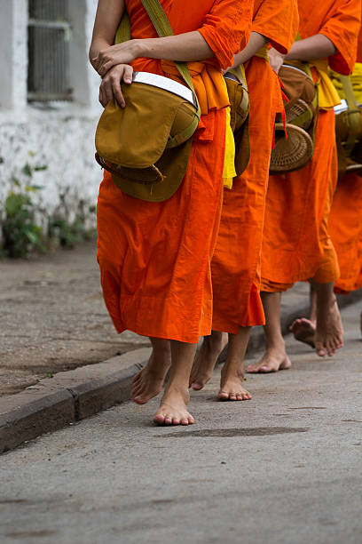 istock buddhist monks walking to receive offerings 180926958