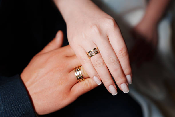 Female and male hand with wedding rings.