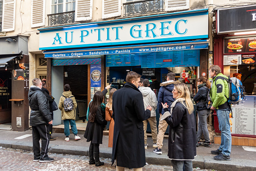 Paris, France, 21th of November 2023, Crowds buying fast food in the street (rue mouffetard) of Paris,