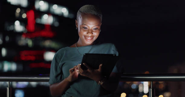 istock Tablet, night balcony or laughing woman reading funny social network feedback, customer experience or ecommerce. Brand monitoring data, website info or African media worker doing online survey review 1809277964