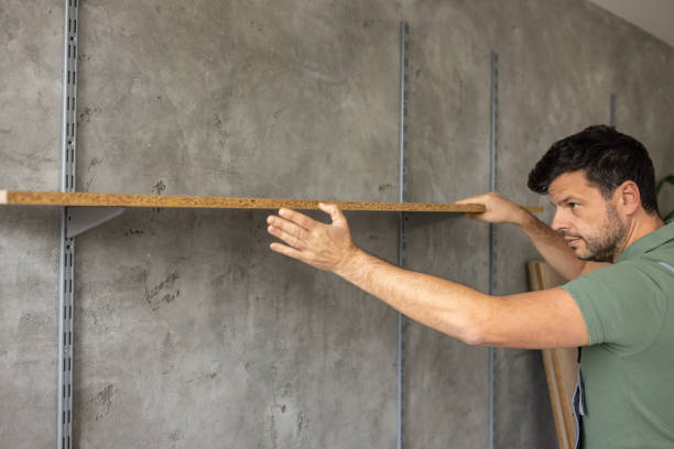 istock Handyman installing a shelf in an apartment 1809281287