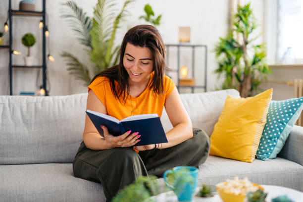 istock Young Woman Reading A Book At Home 1809293255