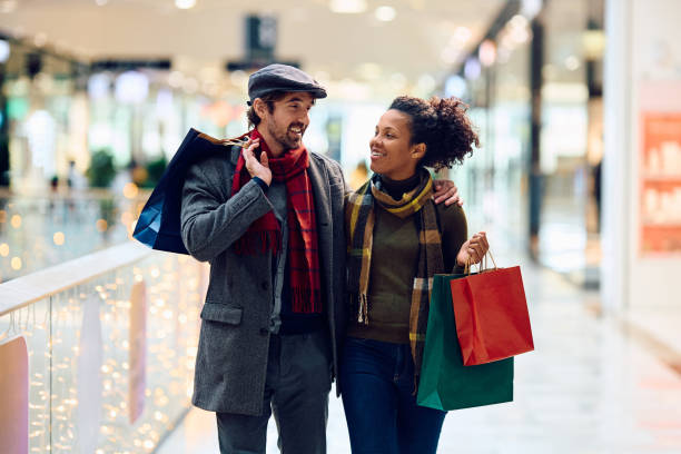 istock Happy multiracial couple communicating while shopping at the mall. 1809294871