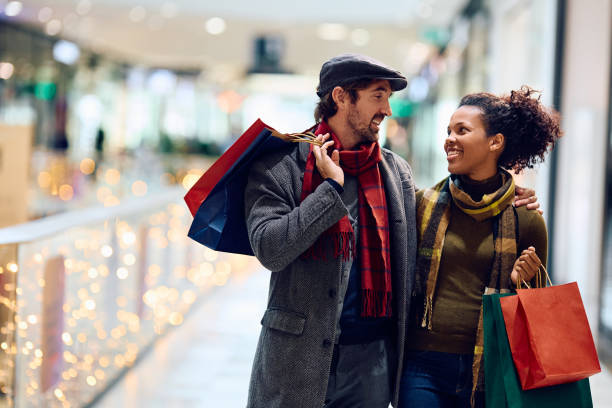 istock Happy couple talking while walking through shopping mall. 1809294879