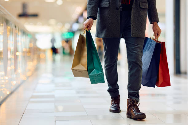 istock Unrecognizable man with shopping bags walking through the mall. 1809295401