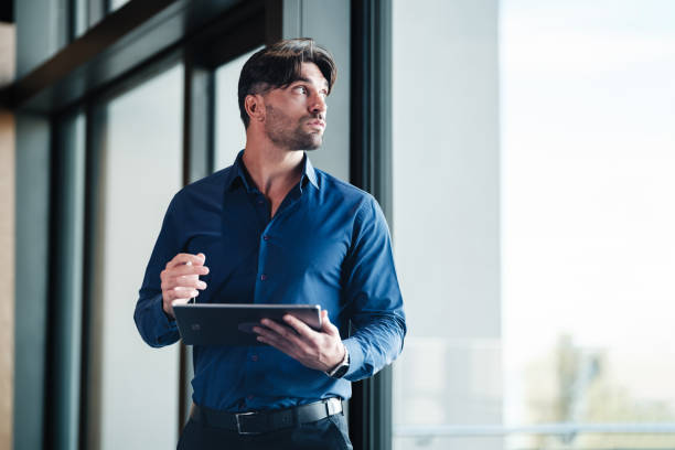 istock Young businessman using digital tablet outdoors on the office terrace 1809300346