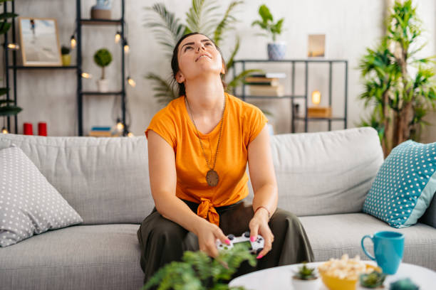 istock Young Woman Playing Video Games At Home 1809302037