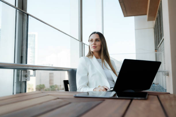 istock businesswoman working using her laptop on the office terrace 1809333664