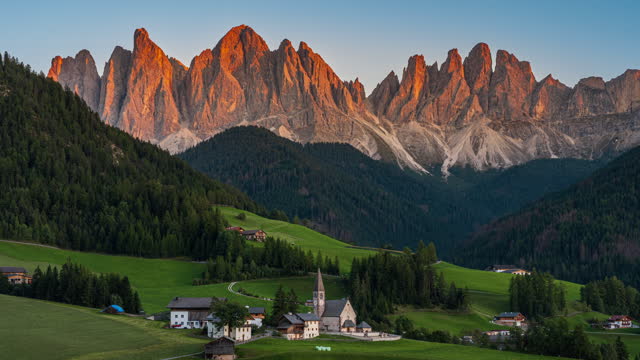 Footage Day to Night Time lapse Scene of Church of St. Magdalena or Santa Maddalena Village over the mountain range in  Dolomites Alps Mountian, South Tyrol, Val di Funes, Italy