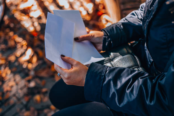 istock A girl opens a white envelope with a check. Payroll Check. Holding Salary Cheque. Woman With Paycheck. 1809342336