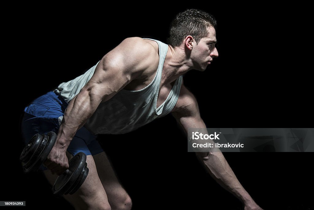 Poderoso muscular homem levantando halteres em fundo preto - Foto de stock de Adulto royalty-free