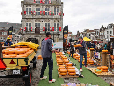 Gouda, the Nehterlands - April 20, 2023: The famous cheese market at the town hall in Gouda, the Nehterlands