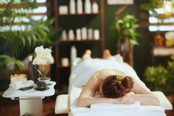 istock relaxed modern woman in massage cabinet laying on massage table 1809353312