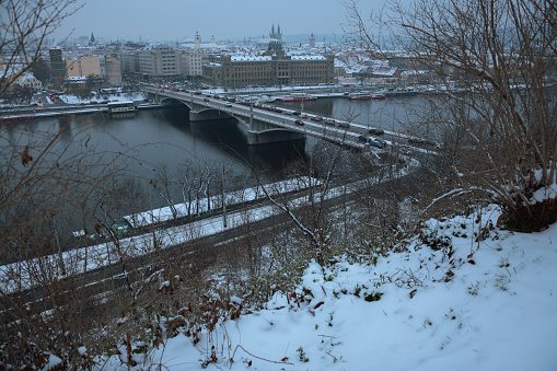 landscape in winter in Prague, Czech Republic with Vltava river and bridge.
