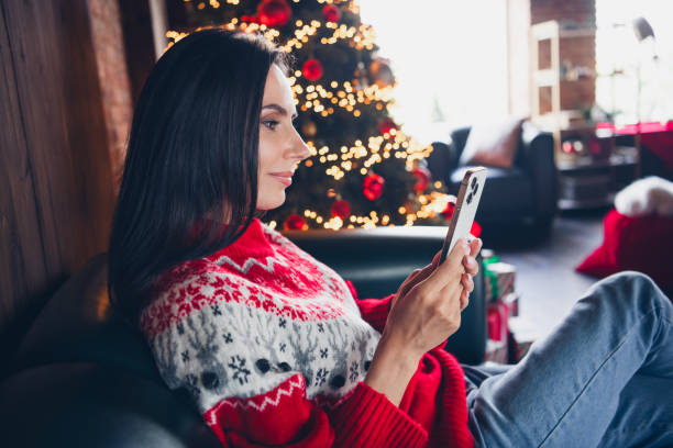 istock Photo of adorable cute girl dressed red pullover sitting comfy sofa writing sms greetings congratulations magic weekend indoors 1809366220