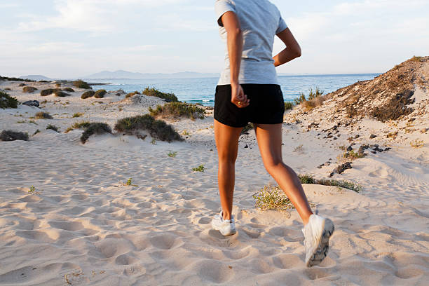 Female Indian jogger jogging on a beach