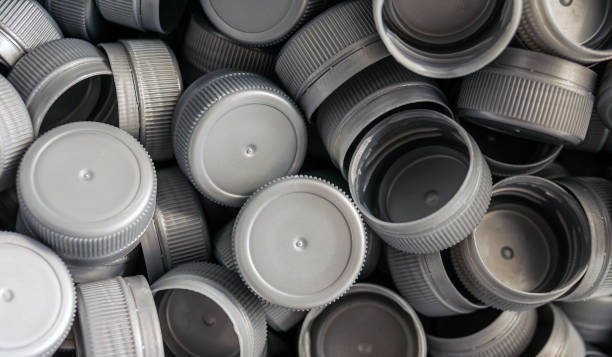 istock Top view grey plastic bottle caps.Recycling collection and production processing plastic bottle caps background 1809369348