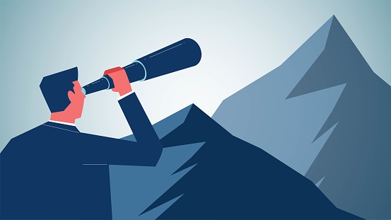 Business or career forecasts, business goals and plans, new pursuits and goals, challenging the odds to achieve a goal, businessman standing at the top of a mountain with binoculars to see further up the mountain