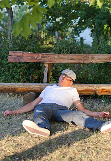 istock Drug addict lying in a park 180939180