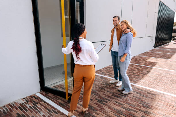 istock Real estate agent opening door for customers 1809392652