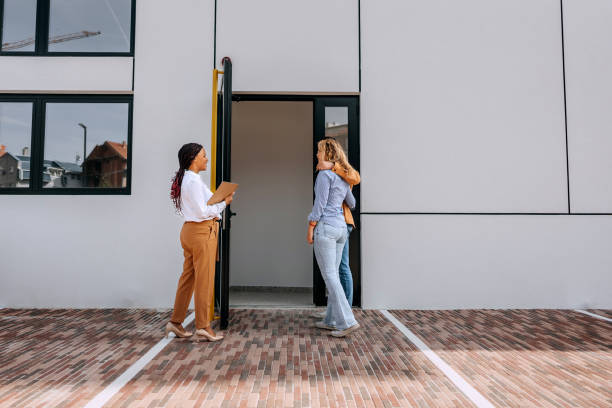 istock Real estate agent opening door for customers 1809392678