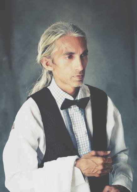 A striking portrait of a handsome North African man dressed in a stylish suit. His confident expression and professional attire highlight his charm and sophistication