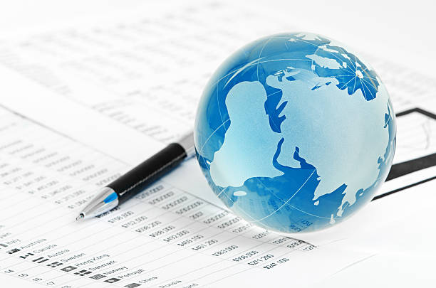 istock Glass globe and pen on finance 180940415