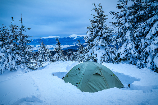 Tourist tent in the snow after blizzard snowstorm in the Carpathian mountains
