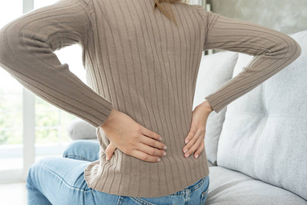 istock woman holding her lower back while and suffer from unbearable pain health and problems, chronic back pain, backache in office syndrome, scoliosis, herniated disc, muscle inflammation 1809406743